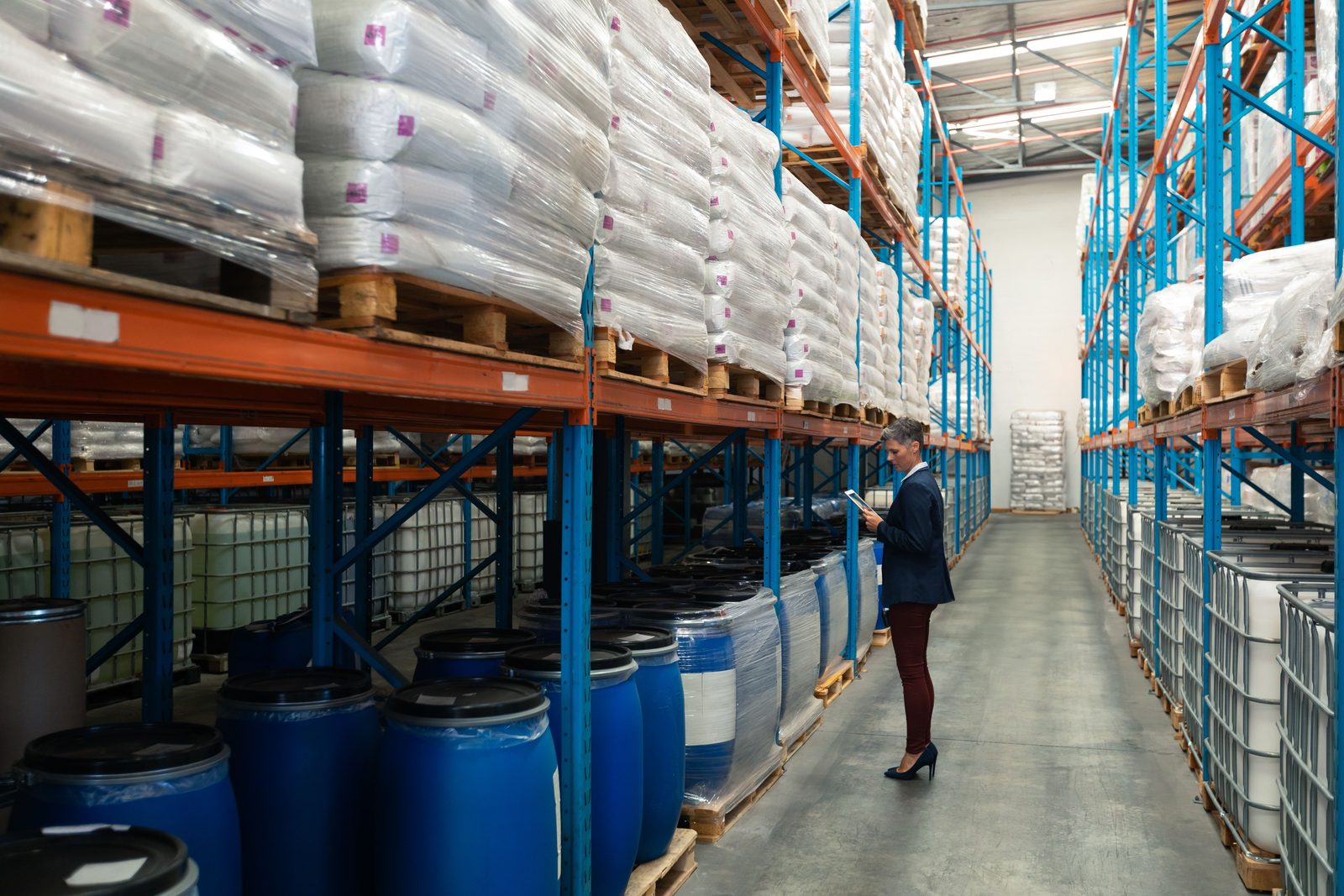 Warehouse racks of chemical drums and bagged goods