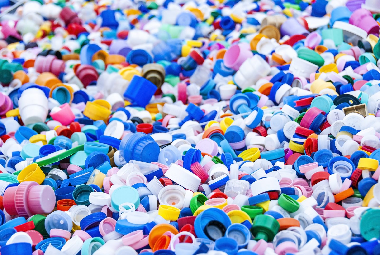 Heap of colourful plastic bottle caps sorted for recycling
